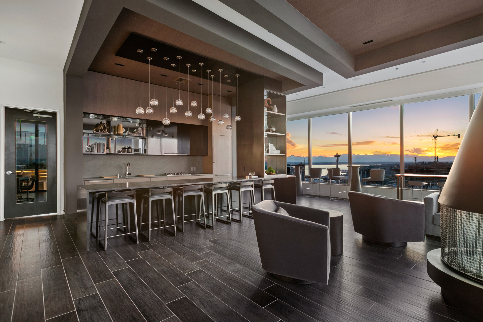 HDR interior photograph of a luxury lounge with city sunset views